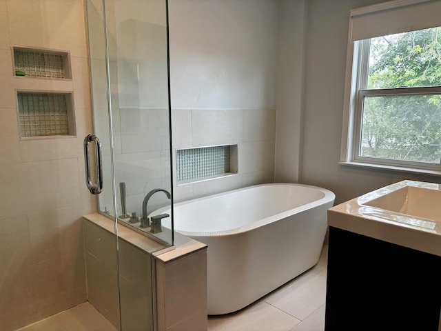 404 Pauline Blvd, Ann Arbor, MI 48103 - bathroom featuring a stall shower, a freestanding tub, a sink, and tile patterned flooring