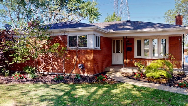 26817 Newport Ave, Warren, MI 48089 - view of front of home featuring brick siding, a front lawn, a chimney, and roof with shingles