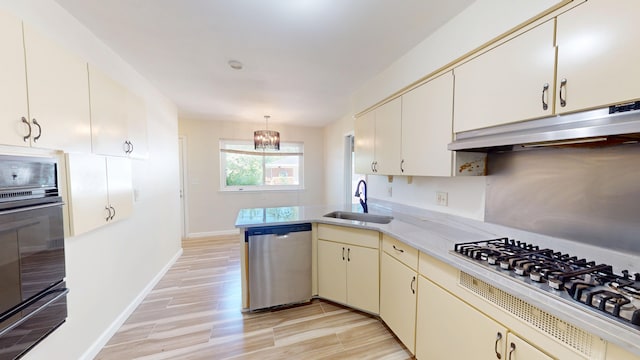 26817 Newport Ave, Warren, MI 48089 - kitchen featuring a sink, appliances with stainless steel finishes, under cabinet range hood, a warming drawer, and a chandelier