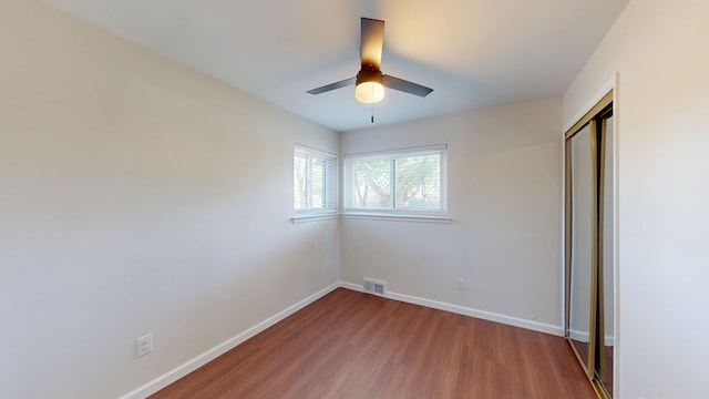 26817 Newport Ave, Warren, MI 48089 - unfurnished bedroom featuring wood finished floors, a closet, baseboards, and a ceiling fan