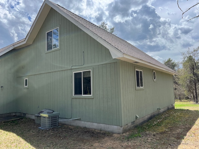 11055 Kopko Trl, Roscommon, MI 48653 - view of side of property featuring central AC unit, a shingled roof, and crawl space