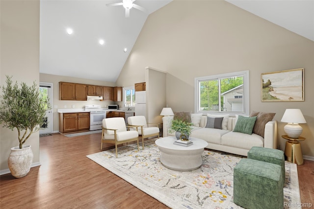 3819 Hazelett Dr, Waterford, MI 48328 - living room featuring high vaulted ceiling, a ceiling fan, healthy amount of natural light, and light wood-style floors