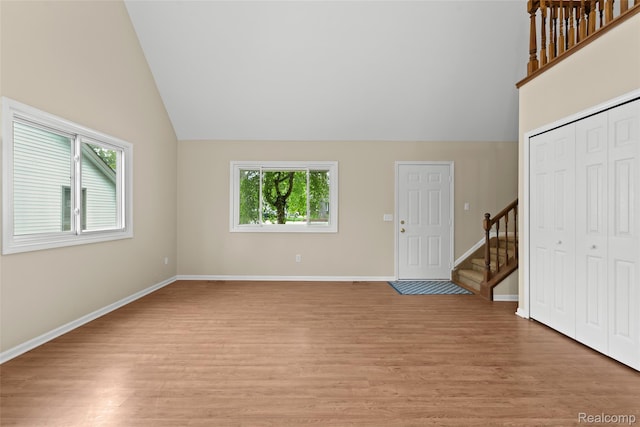 3819 Hazelett Dr, Waterford, MI 48328 - foyer entrance with lofted ceiling, light wood-style floors, stairs, and baseboards
