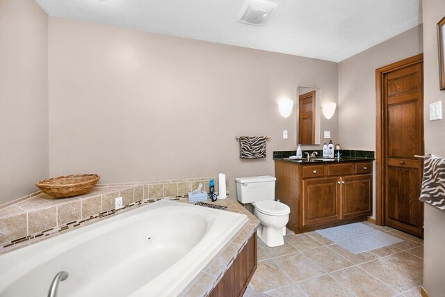 838 Able Rd, Buchanan, MI 49107 - bathroom featuring a jetted tub, toilet, vanity, and tile patterned flooring