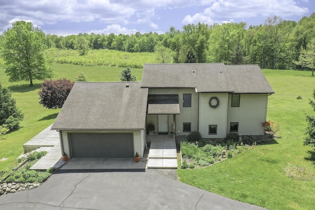 838 Able Rd, Buchanan, MI 49107 - view of front of property featuring asphalt driveway, a front lawn, a shingled roof, and a garage