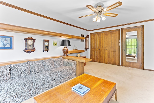 carpeted living area with ceiling fan and crown molding