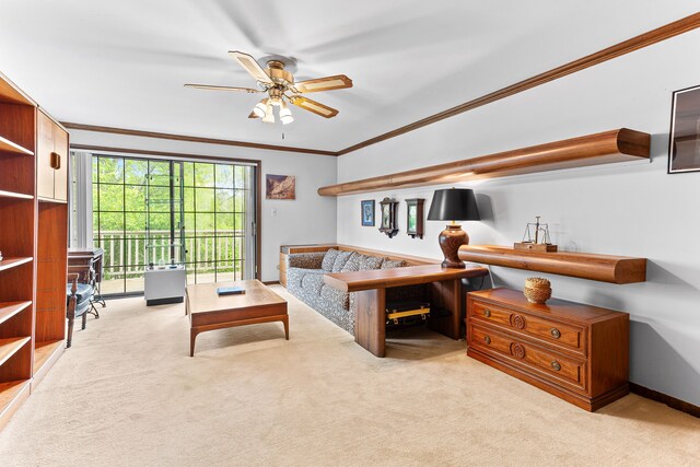 living room featuring carpet, ornamental molding, and ceiling fan