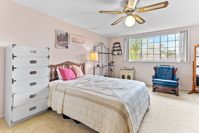 bedroom with light colored carpet and ceiling fan