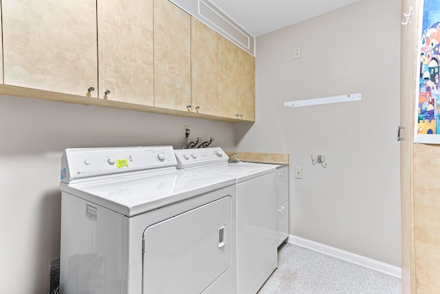 laundry room featuring cabinet space, washer and dryer, and baseboards