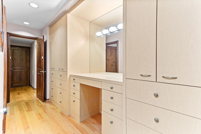 bathroom with wood finished floors, recessed lighting, and vanity