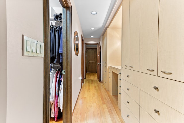 hall with light wood-style floors and recessed lighting
