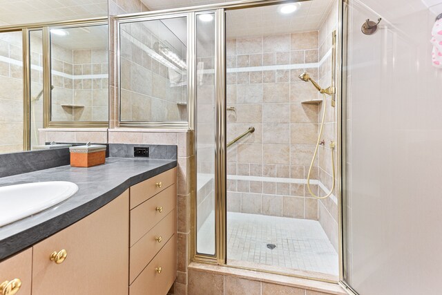 bathroom with a stall shower, vanity, and recessed lighting