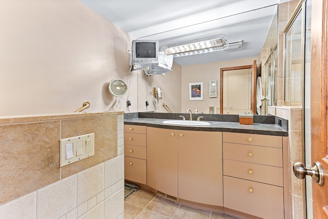 full bath featuring vanity, tile patterned floors, and a shower with shower door