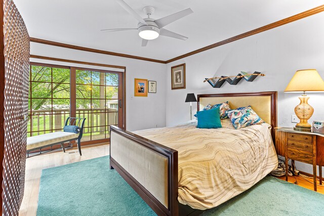 bedroom featuring access to exterior, wood finished floors, crown molding, and a ceiling fan