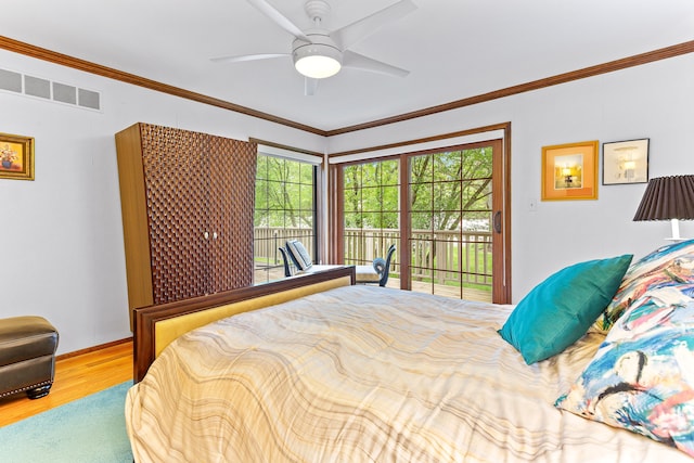 bedroom with access to exterior, wood finished floors, ornamental molding, ceiling fan, and baseboards