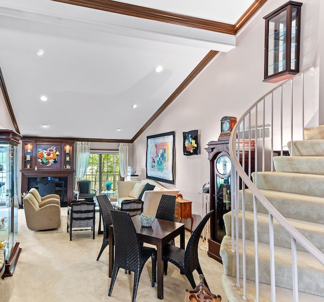 carpeted dining space with crown molding, stairs, recessed lighting, and a glass covered fireplace