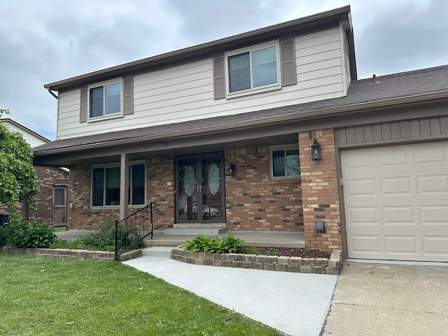 view of front of property featuring brick siding, a porch, and a front yard