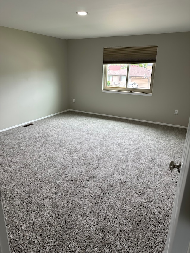 empty room with carpet, baseboards, and recessed lighting