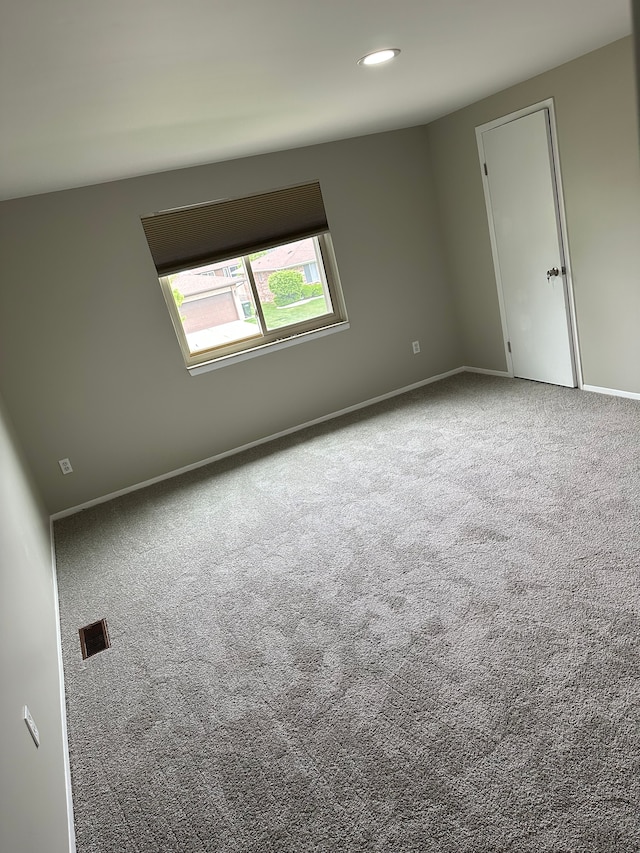 carpeted empty room featuring baseboards and recessed lighting