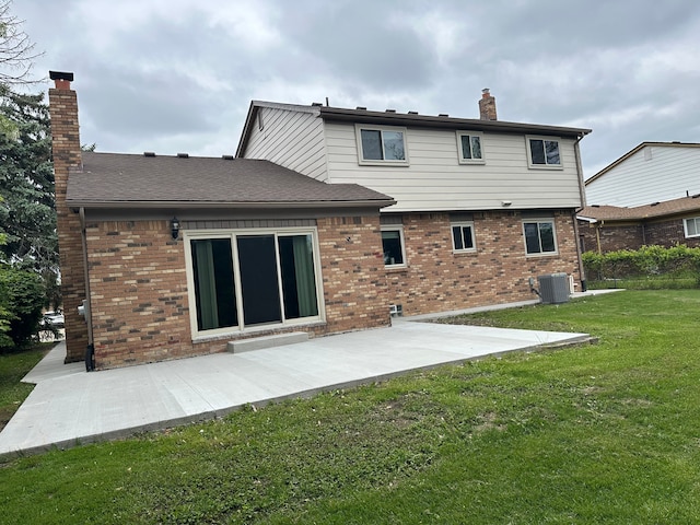 back of property featuring a chimney, a patio, and brick siding
