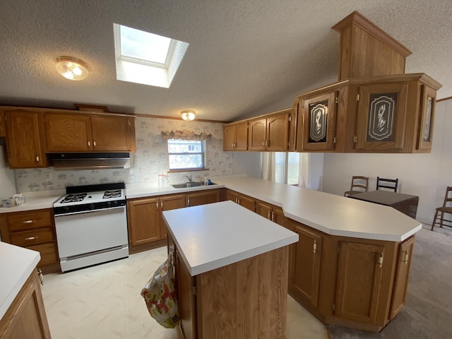 1966 Spyglass Trl, Muskegon, MI 49442 - kitchen with white range with gas stovetop, a sink, brown cabinets, wallpapered walls, and a skylight
