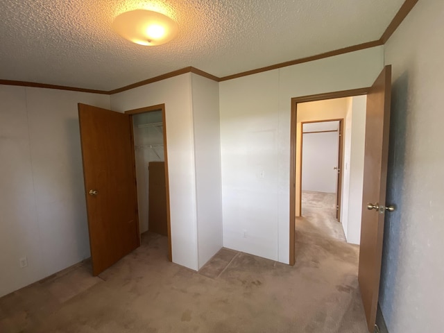 1966 Spyglass Trl, Muskegon, MI 49442 - unfurnished bedroom featuring ornamental molding, light carpet, a closet, and a textured ceiling