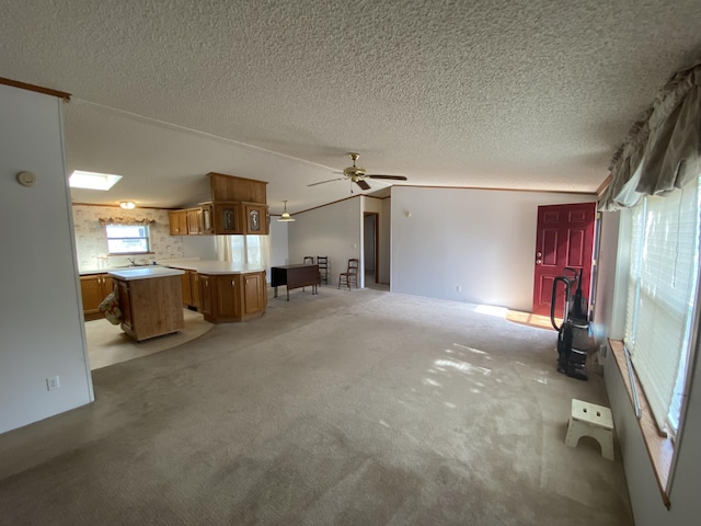 1966 Spyglass Trl, Muskegon, MI 49442 - unfurnished living room with light carpet, a textured ceiling, and a ceiling fan