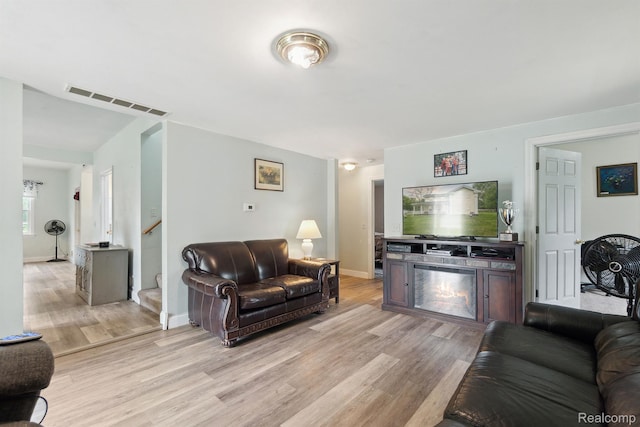5160 N Milford Rd, Highland, MI 48356 - living area with light wood finished floors, stairs, and baseboards