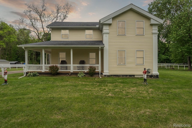 5160 N Milford Rd, Highland, MI 48356 - back of property at dusk featuring covered porch and roof with shingles