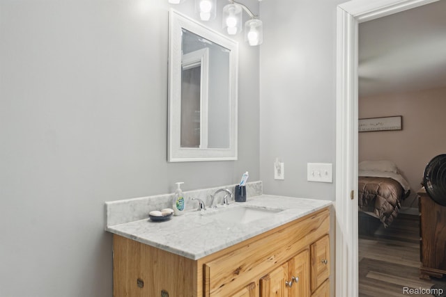 5160 N Milford Rd, Highland, MI 48356 - bathroom featuring vanity, wood finished floors, and ensuite bath