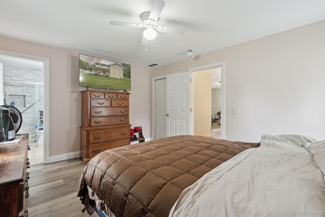 5160 N Milford Rd, Highland, MI 48356 - bedroom with light wood finished floors, baseboards, a closet, and ceiling fan