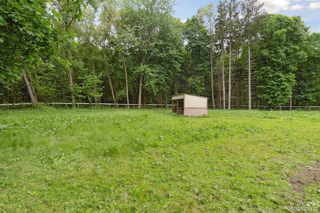 5160 N Milford Rd, Highland, MI 48356 - view of yard with an outdoor structure and a view of trees