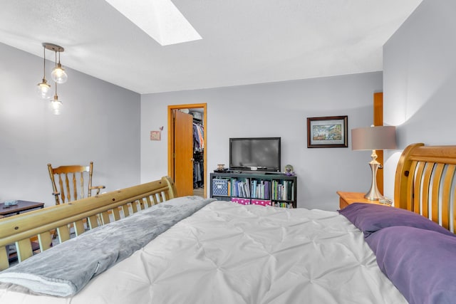 65505 M 43, Bangor, MI 49013 - bedroom featuring a skylight, a walk in closet, lofted ceiling, a textured ceiling, and a closet