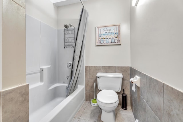 65505 M 43, Bangor, MI 49013 - full bathroom featuring tile patterned floors, tile walls, toilet, wainscoting, and shower / tub combo
