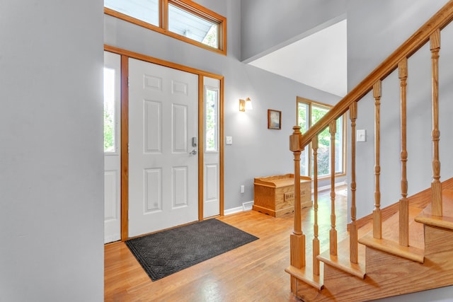 65505 M 43, Bangor, MI 49013 - foyer with stairway, light wood-style flooring, a high ceiling, and baseboards
