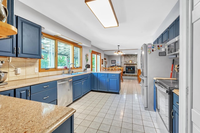 65505 M 43, Bangor, MI 49013 - kitchen featuring appliances with stainless steel finishes, blue cabinetry, and a sink