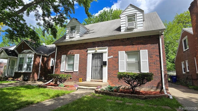 11356 Balfour Rd, Detroit, MI 48224 - new england style home with brick siding, a front lawn, and roof with shingles