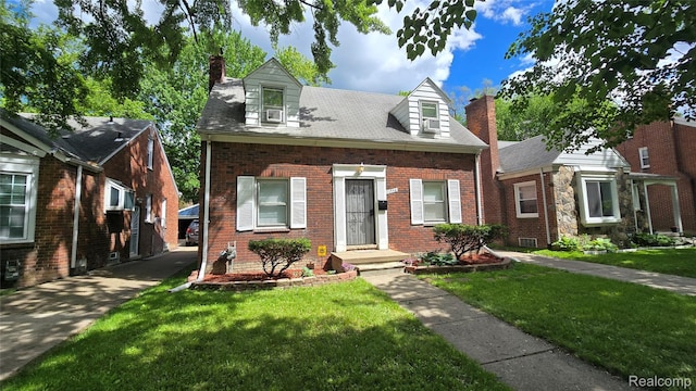 11356 Balfour Rd, Detroit, MI 48224 - cape cod home featuring a chimney, brick siding, and a front lawn