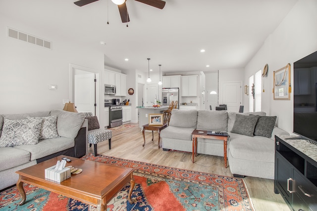 11801 Hines Place Dr, Livonia, MI 48150 - living room with light wood finished floors, a ceiling fan, and recessed lighting