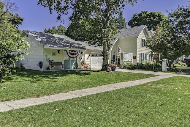 488 4th St, Manistee, MI 49660 - view of front facade with an attached garage, a front yard, concrete driveway, and roof with shingles