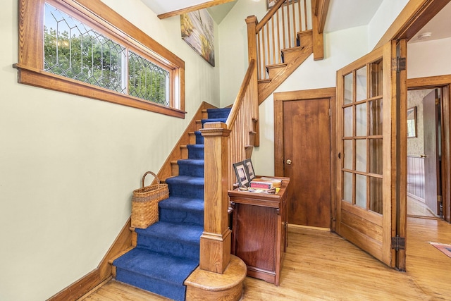 488 4th St, Manistee, MI 49660 - staircase featuring wood finished floors and baseboards