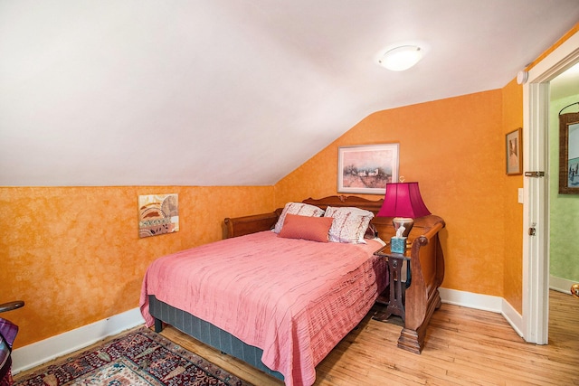 488 4th St, Manistee, MI 49660 - bedroom featuring wood-type flooring, lofted ceiling, and baseboards