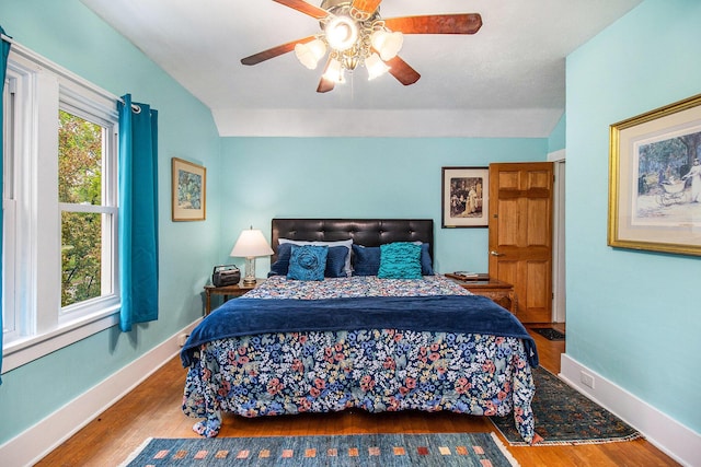 488 4th St, Manistee, MI 49660 - bedroom with wood finished floors, baseboards, and a ceiling fan