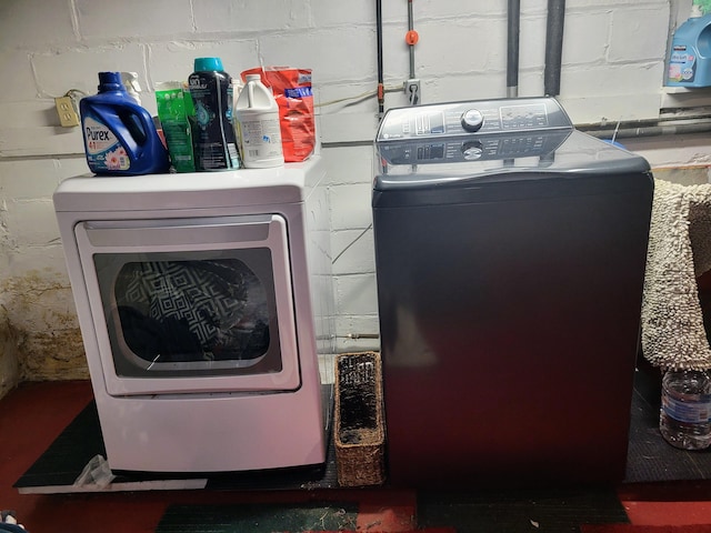 488 4th St, Manistee, MI 49660 - laundry area with separate washer and dryer and concrete block wall