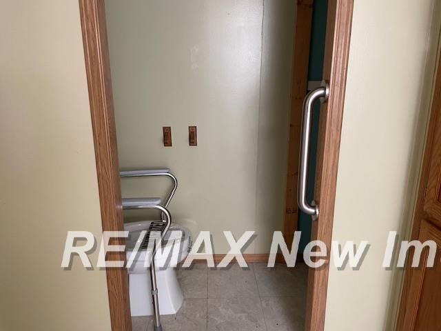 1944 S M 18 Hwy, Gladwin, MI 48624 - washroom featuring tile patterned flooring