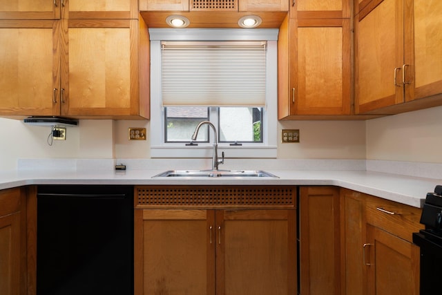 1054 Ferdon Rd, Ann Arbor, MI 48104 - kitchen with dishwasher, a sink, brown cabinetry, and light countertops