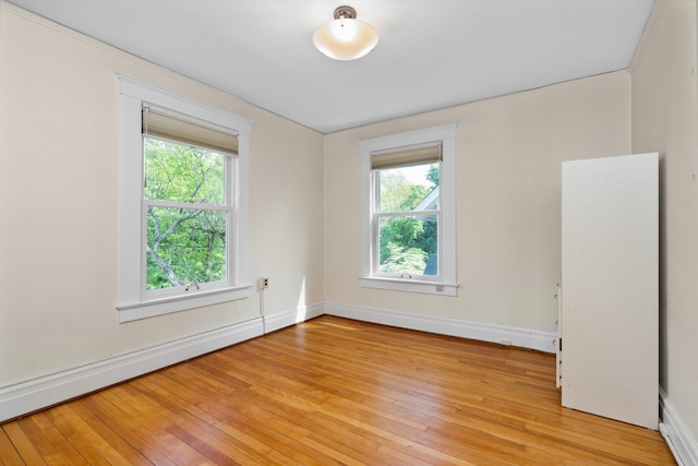 1054 Ferdon Rd, Ann Arbor, MI 48104 - empty room with baseboards, light wood-type flooring, and a baseboard radiator