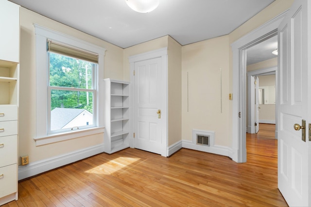1054 Ferdon Rd, Ann Arbor, MI 48104 - unfurnished bedroom with light wood-style floors and baseboards