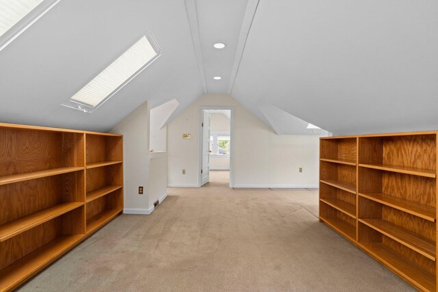 1054 Ferdon Rd, Ann Arbor, MI 48104 - bonus room featuring a skylight, vaulted ceiling, light colored carpet, baseboards, and recessed lighting