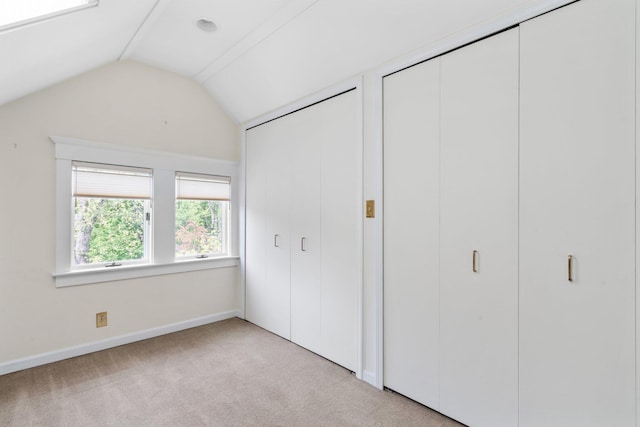 1054 Ferdon Rd, Ann Arbor, MI 48104 - unfurnished bedroom featuring vaulted ceiling, carpet flooring, baseboards, and multiple closets